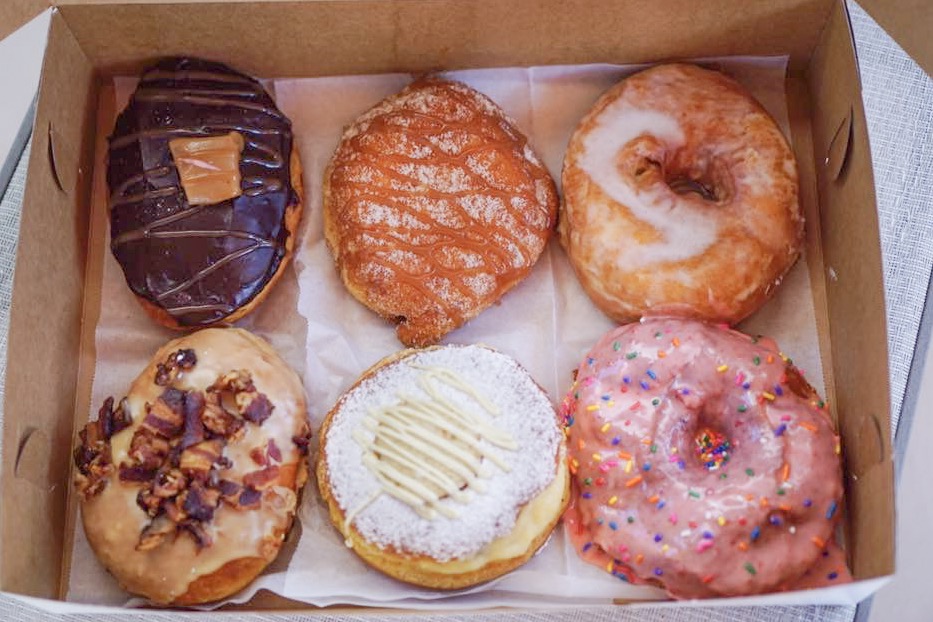 Bos of take out donuts. Take a break from the repetition of cooking and cleaning up multiple meals a day and order out. Pick a few new-to-you restaurants in your city to support and order your food for delivery or curbside pick up! It can be something as simple as donuts or a fancy five-course feast. 