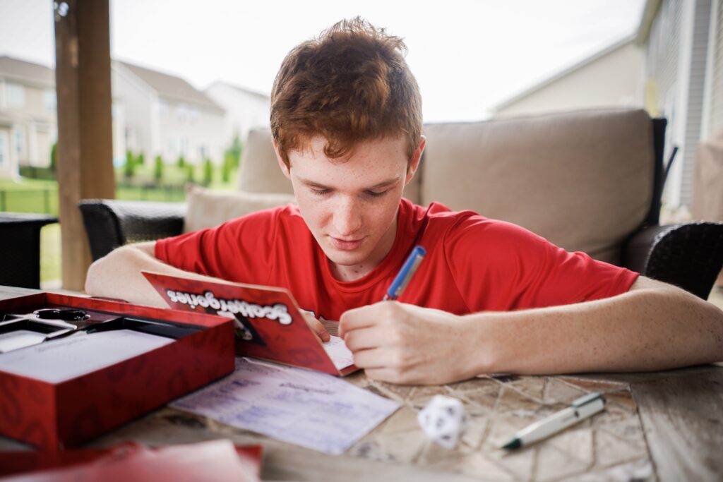 Photo of teen boy playing Scattergories. - Safe Summer Bucket List – 100 Ways to Have Fun This Summer While Social Distancing