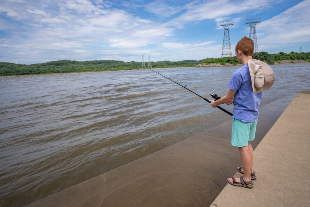 Teenage boy pictured fishing. This leisurely outdoor recreational sport is great for all ages. You may need to apply for a fishing license depending on the rules where you live. 