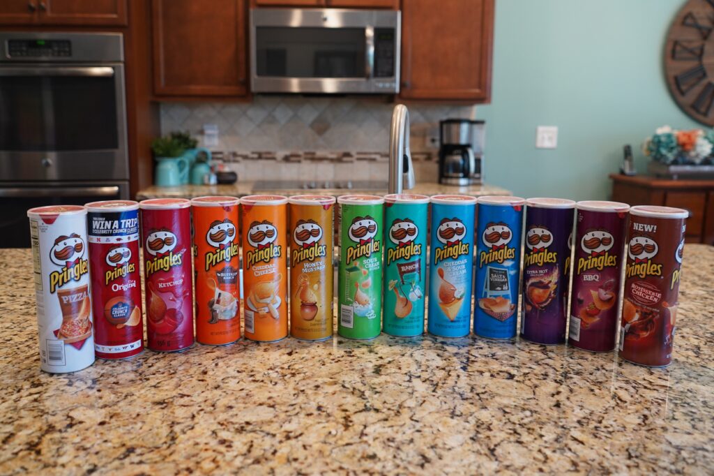 Various flavors of Pringles Potato chips ready for a blind taste test. Prepare an assortment of different foods with the same theme such as fruit or chips and have your family taste them blindfolded and try to guess what they are. Our favorite blind taste test is the Pringles Challenge.