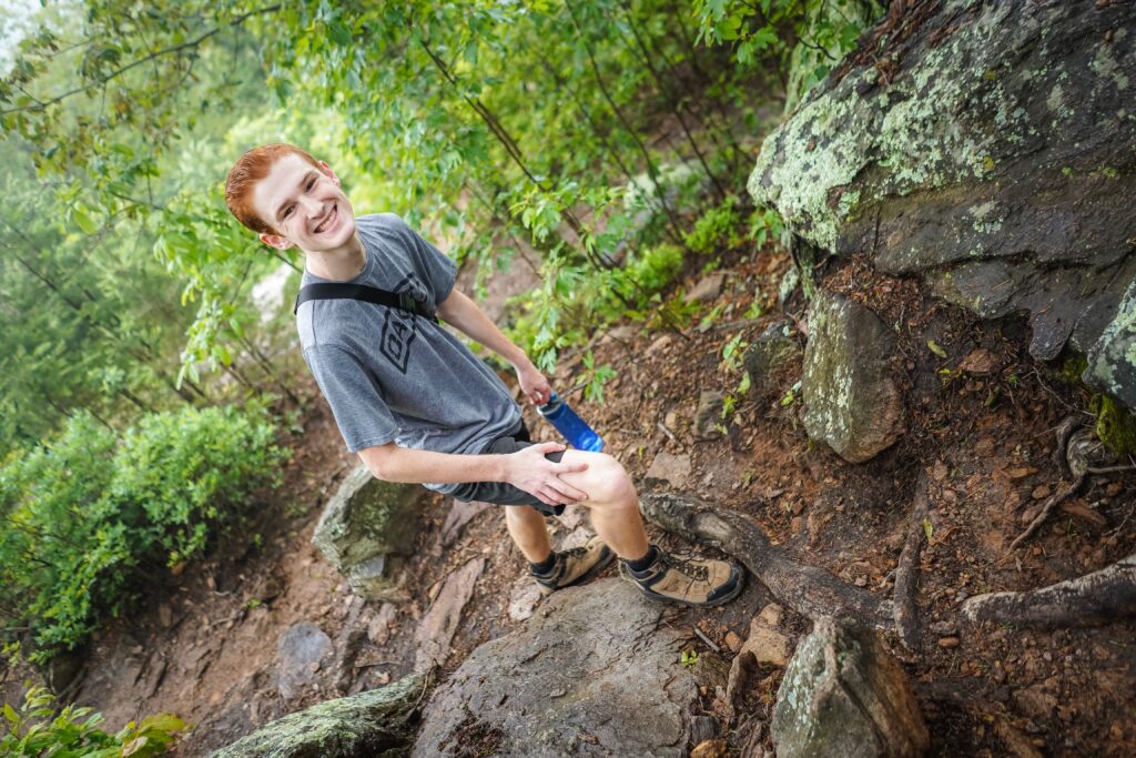 Teen boy pictured hiking on trail. Not only is hiking one of the safest outdoor activities you could enjoy this summer its good to get out in nature. Find a local conservation area or greenway in your area and go for a nice, long family walk. 