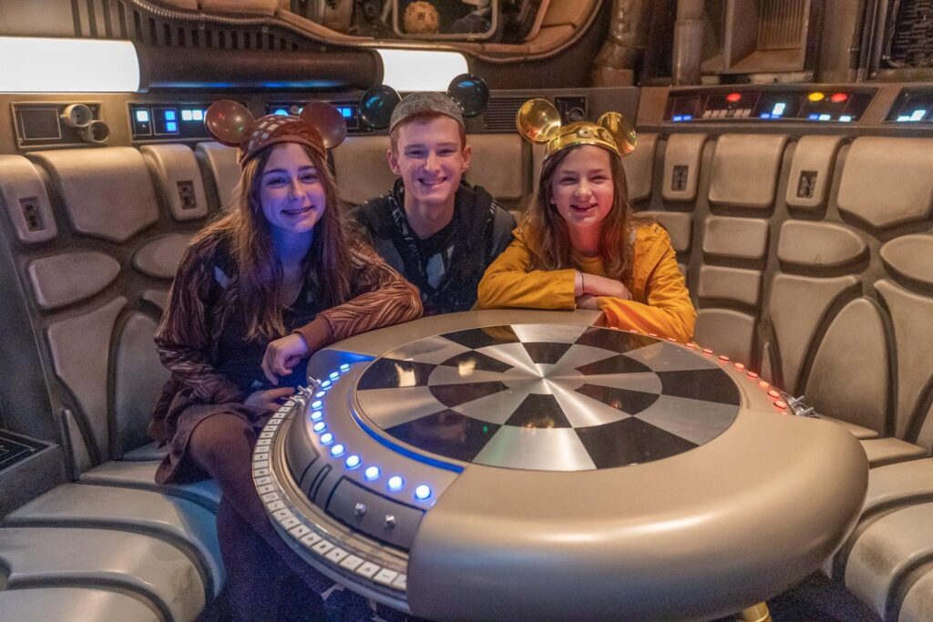 Kids pose with a with a Dejarik “holo-chess” table. Before getting into the cockpit, riders are led into the lounge of the Millennium Falcon. This is a great opportunity to grab some quick photos while you wait in the ride’s immersive queue area.