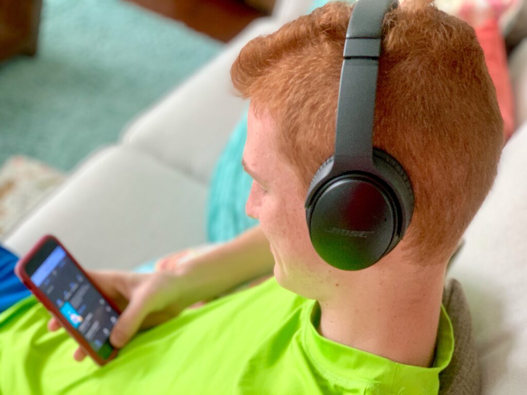 Boy listens to podcasts. From fantastical stories to science explanations, there are podcasts that will appeal podcasts for kids to anyone in your family’s interests.