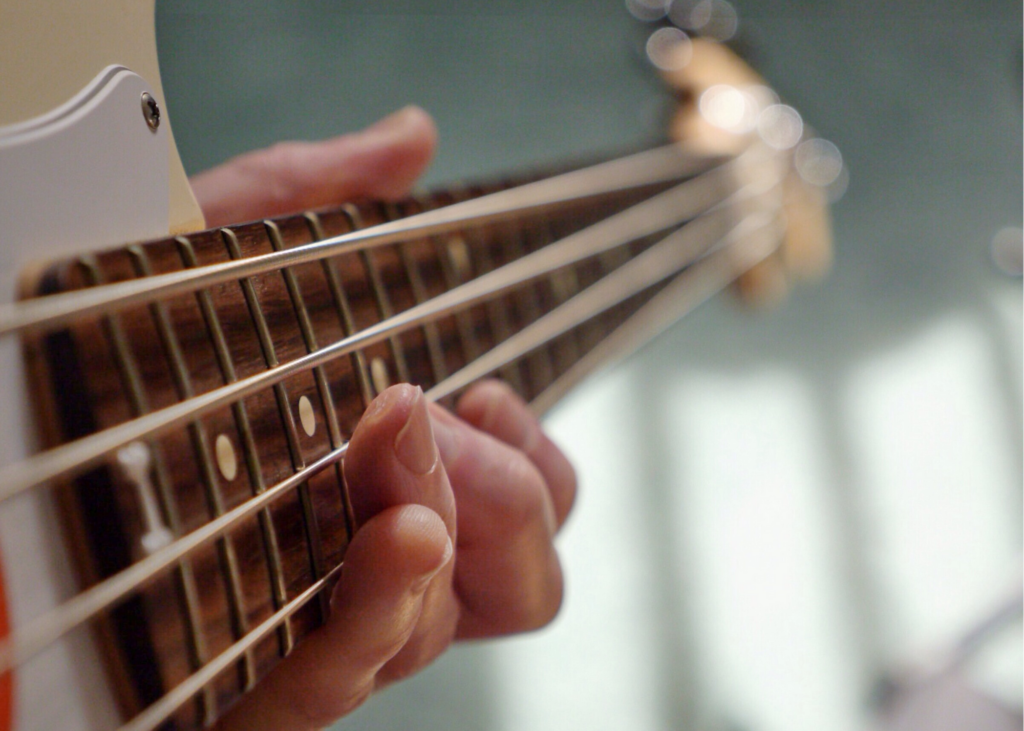 Close up image of playing guitar. There has never been a better time practice your instruments. Don’t have any? Use common household items to make your own. Form a family band and put on a musical show. 