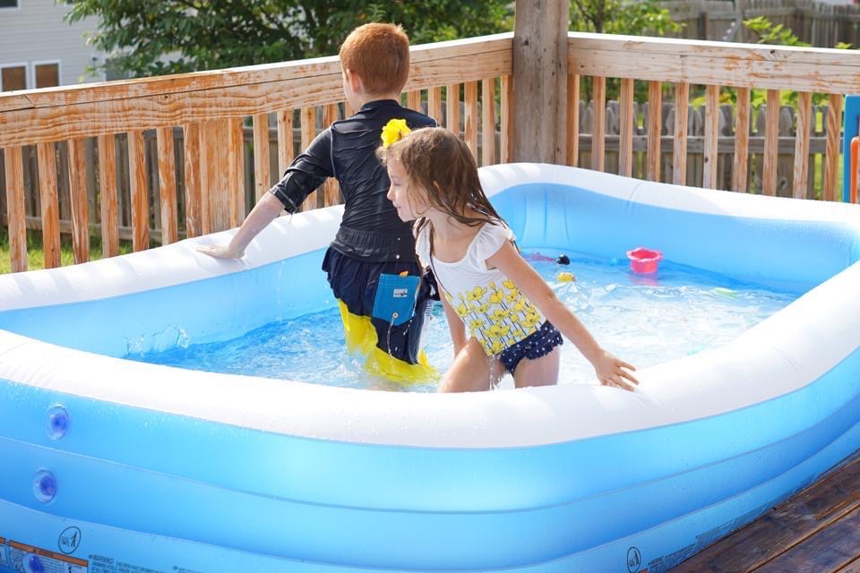 Kids cooling off in a kiddie pool on a hot summer day. 