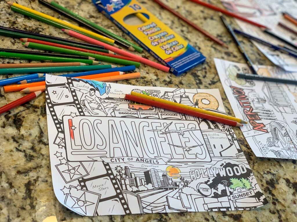 Coloring book page surrounded by colored pancils. There is something calming about coloring at any age. -Safe Summer Bucket List – 100 Ways to Have Fun This Summer While Social Distancing. Grab a coloring book and some crayons or fancy blending markers and enjoy quiet time coloring. 