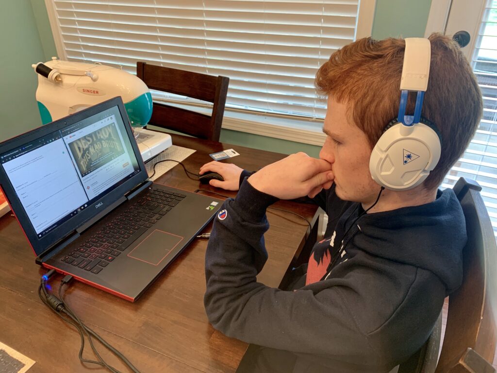 Teen boy uses lap top for virtual visit. Take virtual tour of your favorite museum or one that you have never visited before.. 