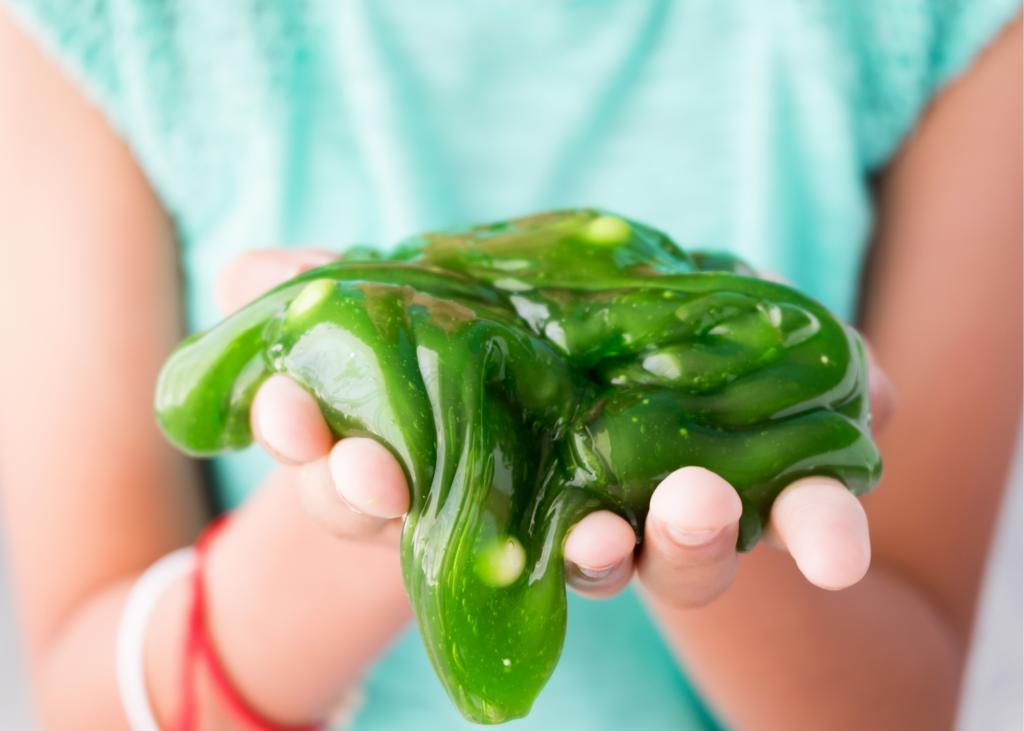 Close-up photo of child holding slime. Kids have been obsessed with the satisfyingly gooey texture of slime and the squishy nature of play-doh for generations. You can pick some up premade slime or you can score some extra cool parent points by making a batch by hand. The kids will love it and you willl pretty much win parent of the year award! 