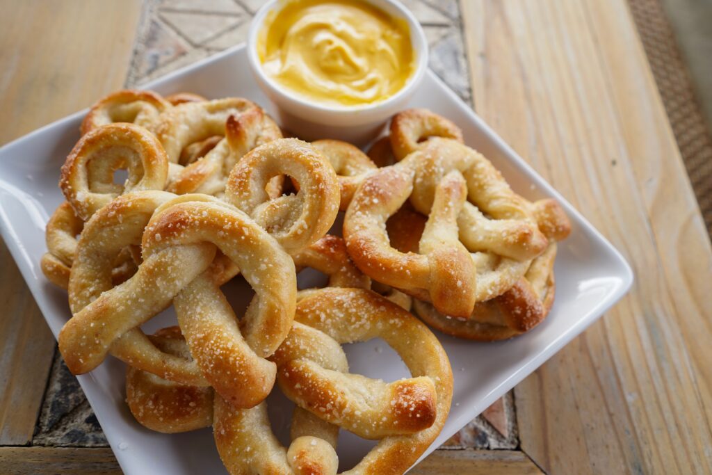 Mickey Shaped Pretzels made at home. Can't take a trip to Disney? Your kids can experience a bit of the magic this summer by making some of their iconic snacks like Dole Whip, Churros, and Mickey-shaped Pretzels right in your kitchen. - Safe Summer Bucket List – 100 Ways to Have Fun This Summer While Social Distancing