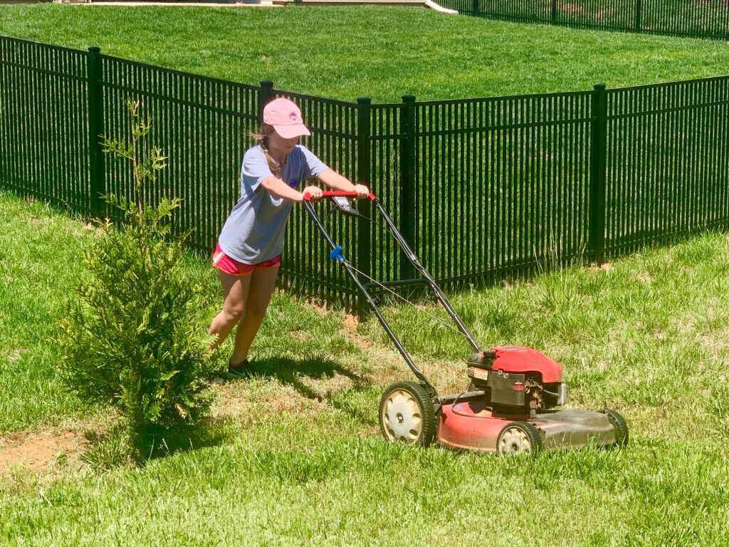 Girl mows lawn. Are your kids trying to earn some cash this summer while social distancing? Now may be the perfect time to train them on how to safely mow your lawn. This could be a new fun job for them and one less chore for you. 