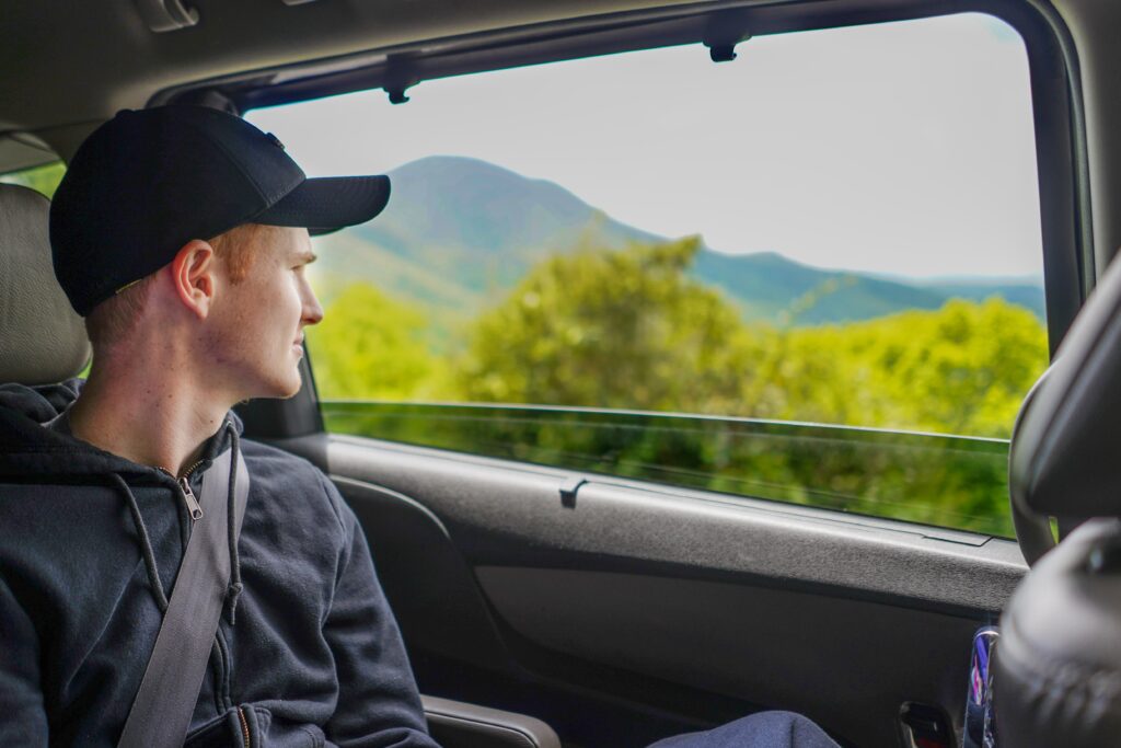 Boy looks out the window on a scenic drive. Hop in the car and head out for a change of view. It doesn’t really matter what the destination is, it’s the journey that counts here. 