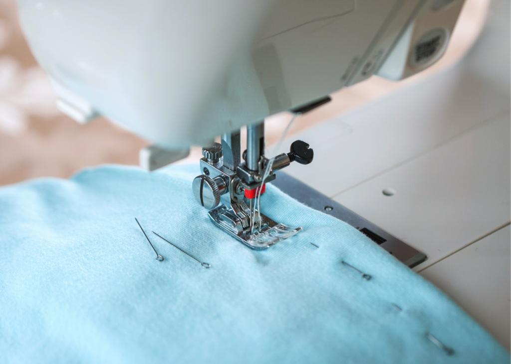 Close up image of sewing machine sewing masks. Get everyone involved in making fun face coverings this summer. Have kids cut fabric, thread elastic, iron pleats or even stitch the seams. It’s a great excuse to learn some simple sewing skills!