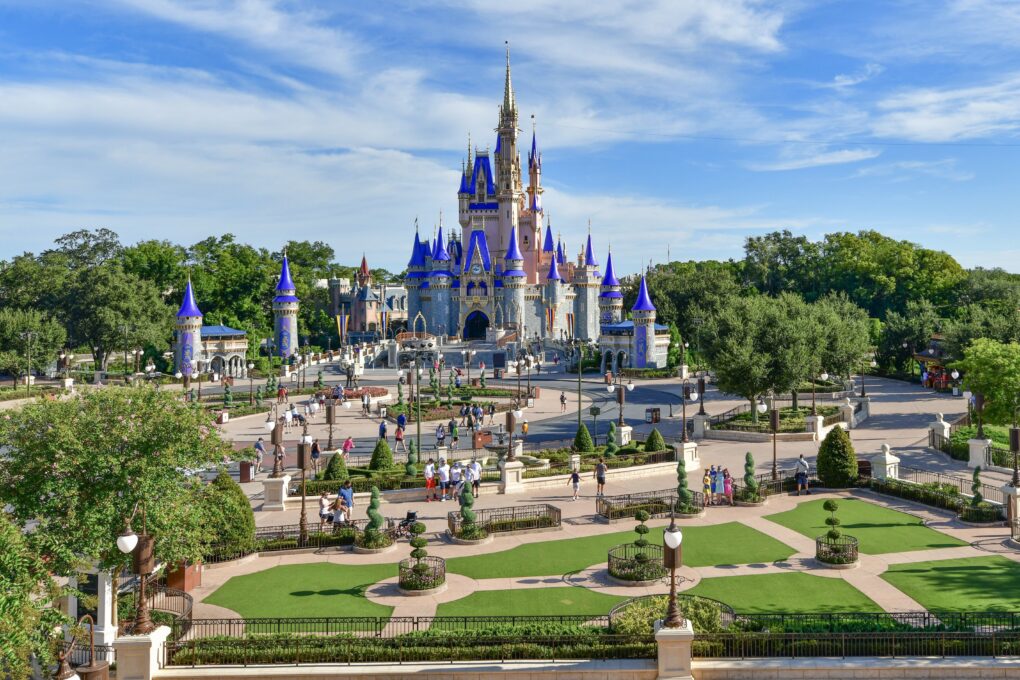 View of Cinderella Castle at the Magic Kingdom with its new pink paint job. Light crowds in front of the castle demonstrate Dinsey's limited capacity restrictions in place during the Coronavirus Pandemic.