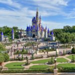 View of Cinderella Castle at the Magic Kingdom with its new pink paint job. Light crowds in front of the castle demonstrate Dinsey's limited capacity restrictions in place during the Coronavirus Pandemic.